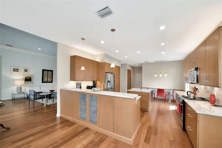 Pass through bar w/ pendant lights and extra storage cabinets.