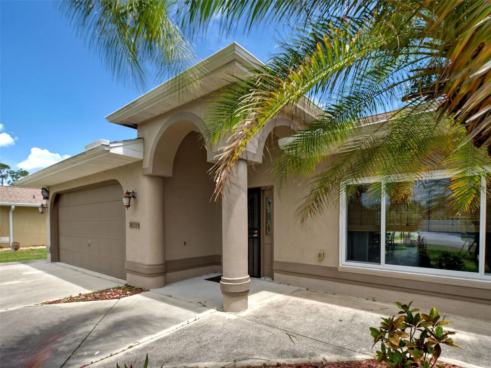 The architectural details around the front door enhance the elegance of this home.