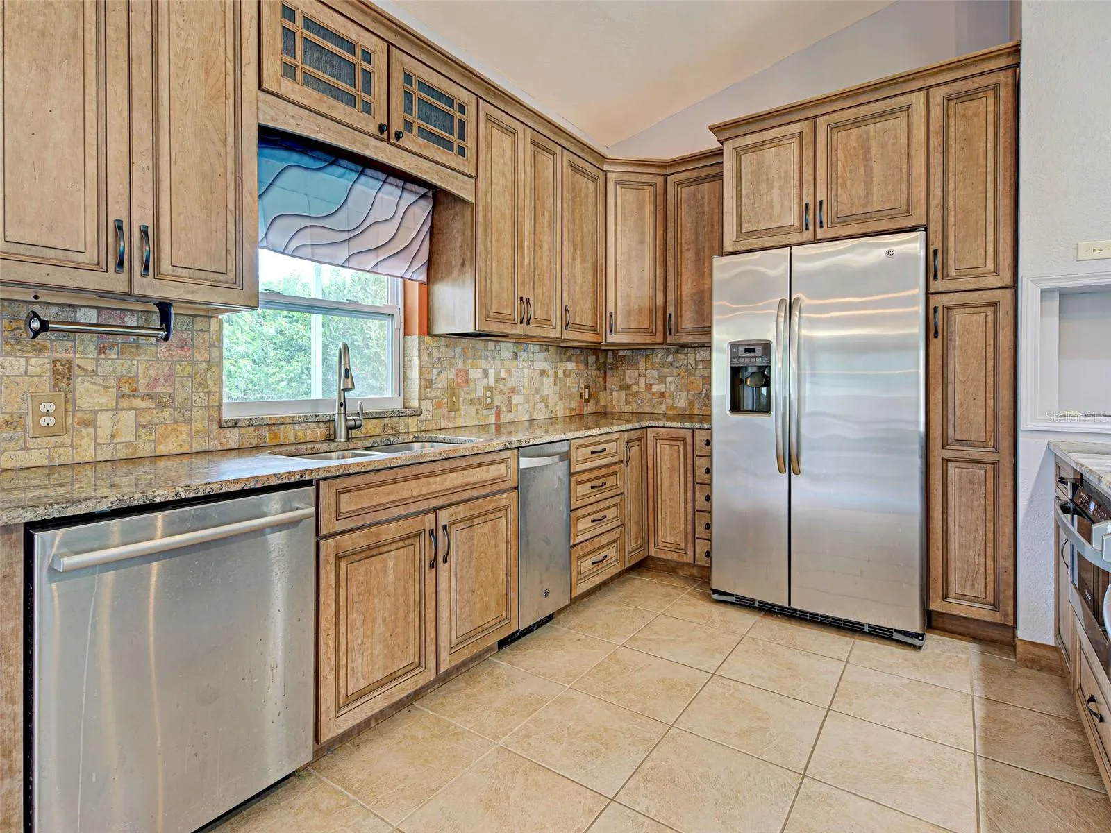 The backsplash blends in perfectly with the stone countertops.