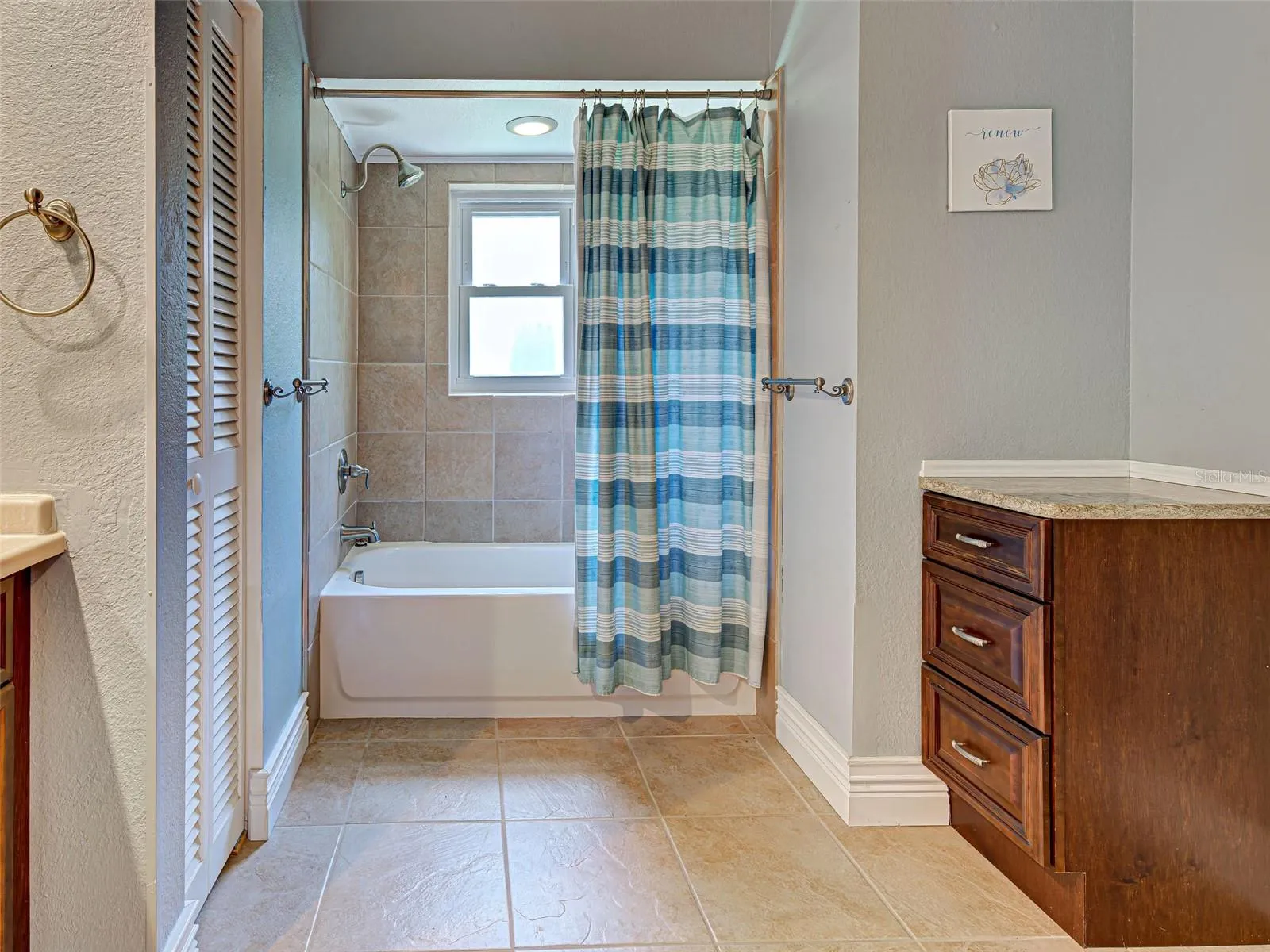 The guest bathroom has a tub/shower combination.