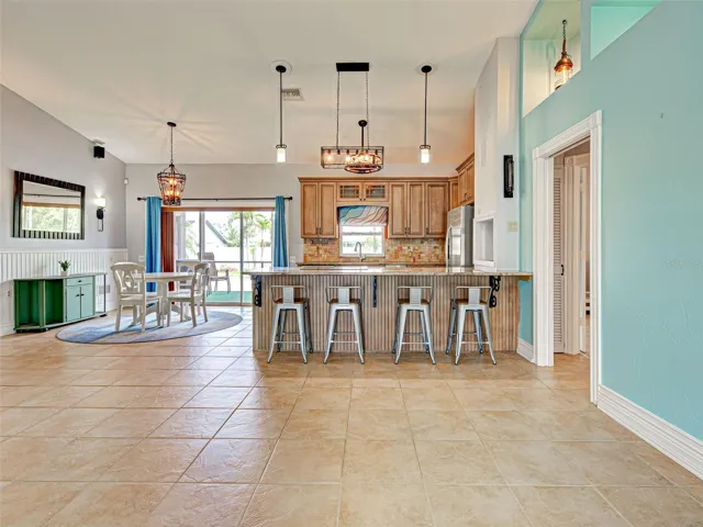 The dining area is steps away from the kitchen and has access to the lanai through the sliding glass doors.  Look at the beautiful light fixtures.