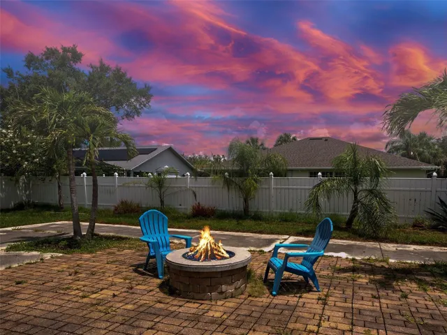 The yard has a huge brick patio with a gas firepit.