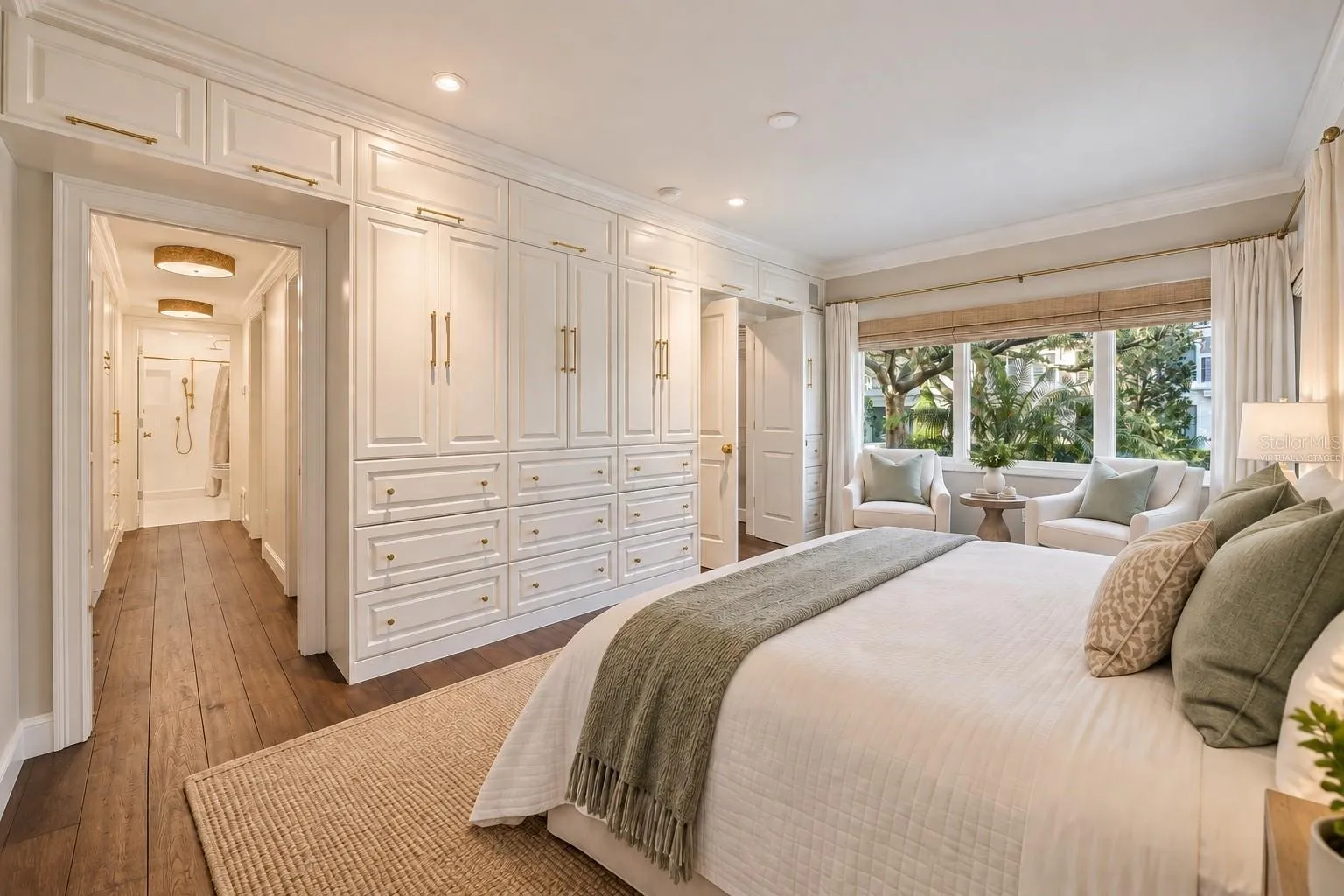 Wall of built-ins in primary bedroom *virtually staged