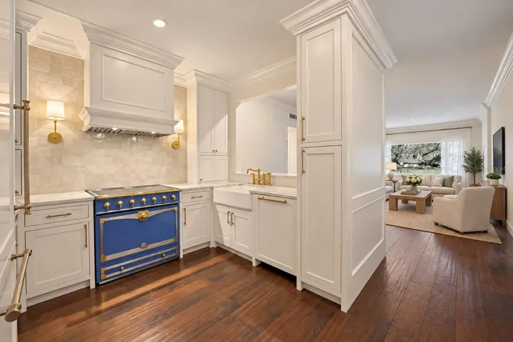 Kitchen with pass-through into living room *virtually staged