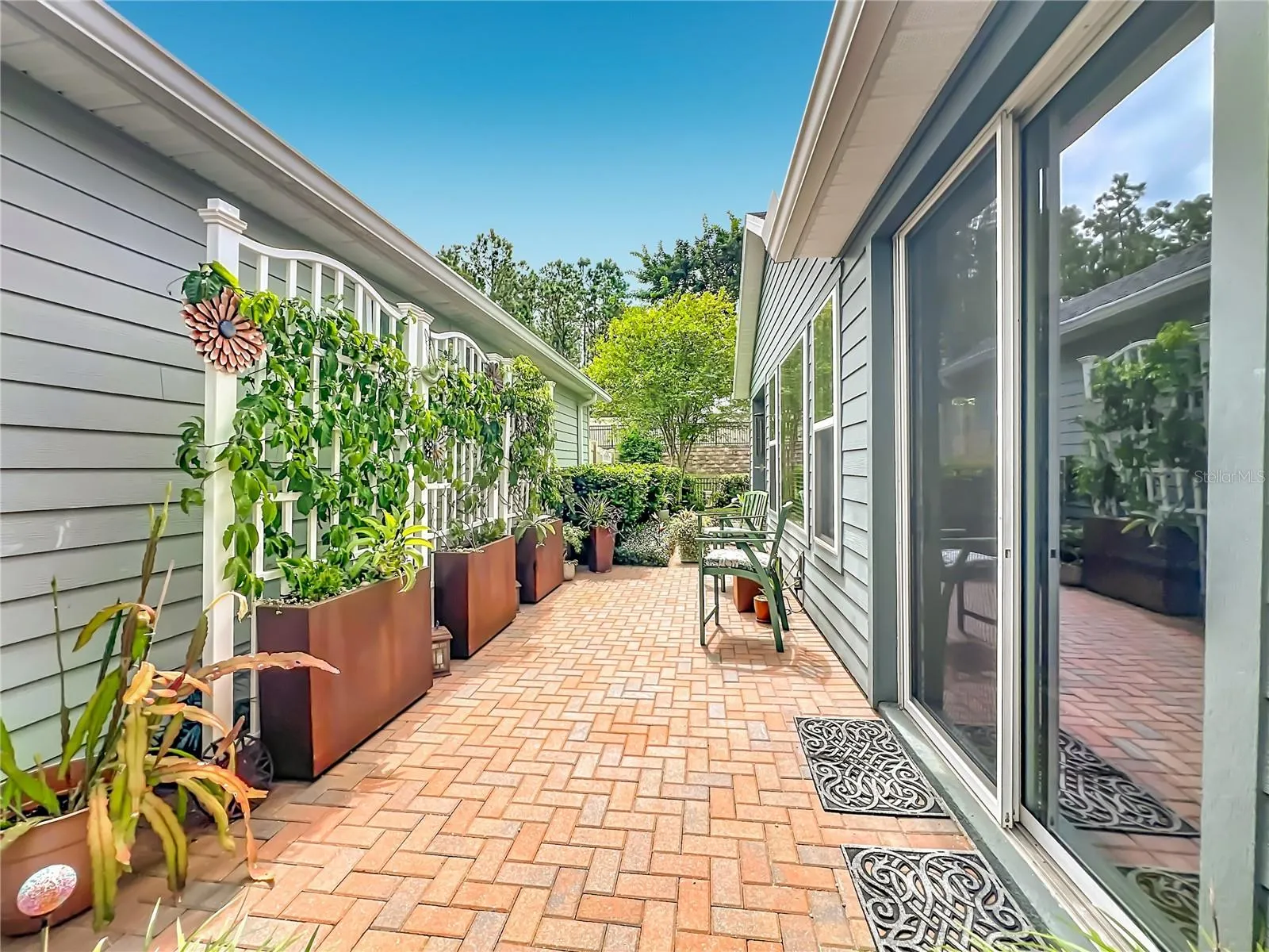 Side patio with tropical landscaping