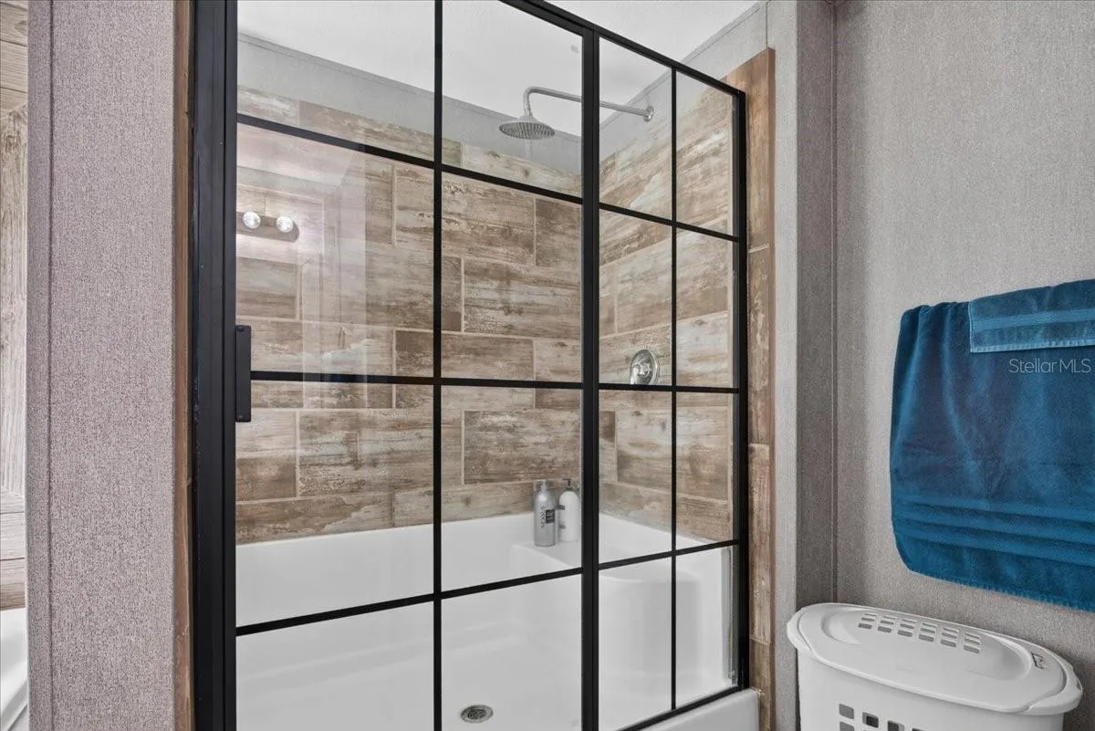 A step in shower with a rain shower and bench for convenience!