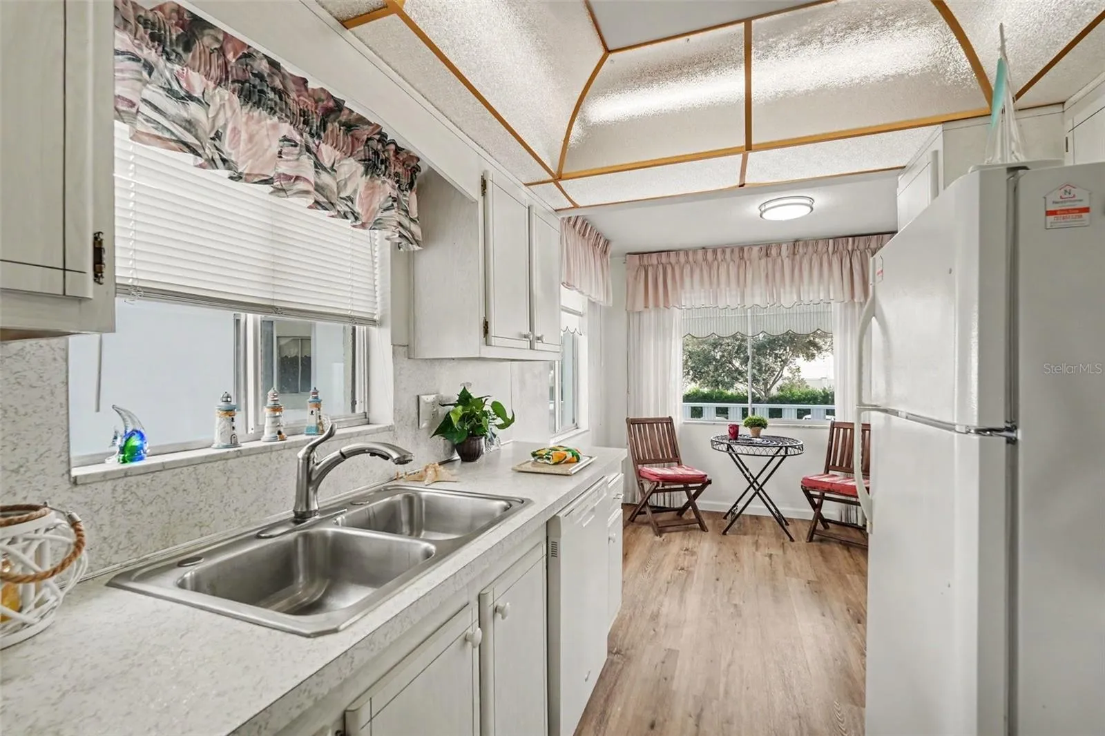 Super cute kitchen has lots of natural light and a view from the sink of the lovely pond with waterfall!