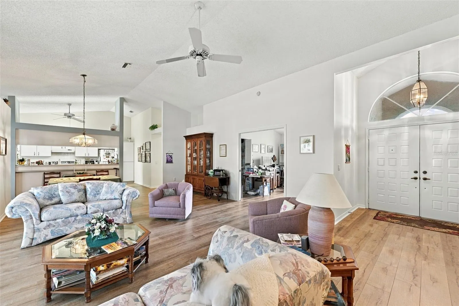 Living room area showing front door and third bedroom entrance