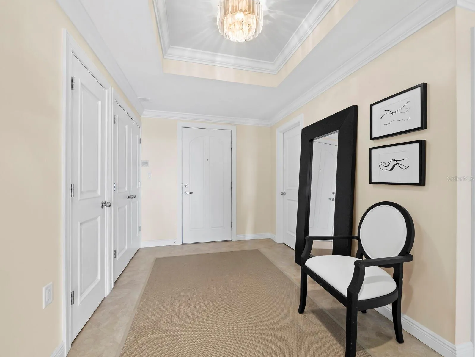 Entry Foyer with coffered ceiling, half bath and large closets