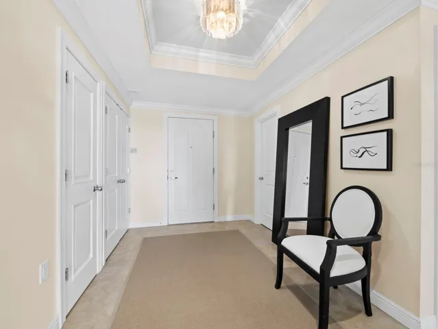 Entry Foyer with coffered ceiling, half bath and large closets
