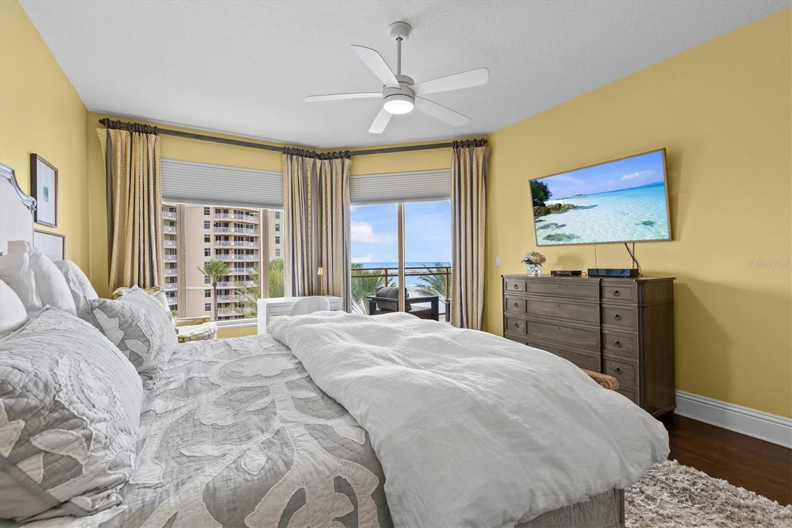 Peaceful primary suite with Gulf views and sliders opening to the private balcony.