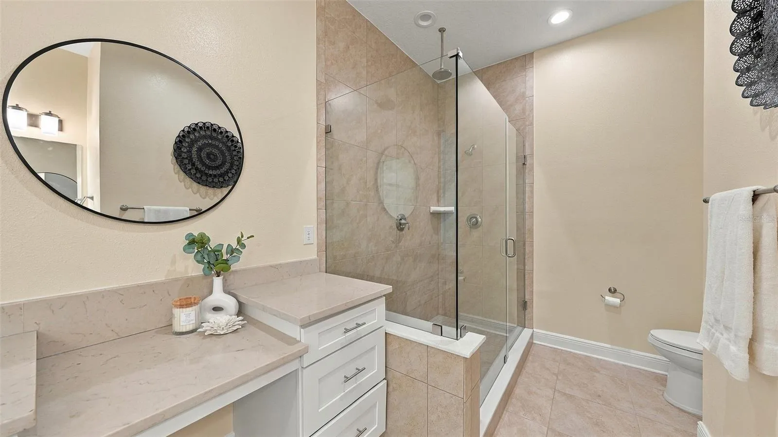 Upgraded primary bathroom with large shower and vanity