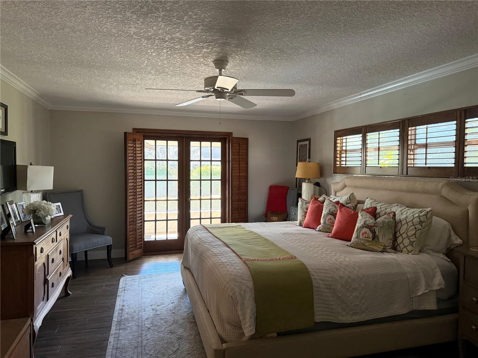 Primary bedroom with french doors to screened porch and pool