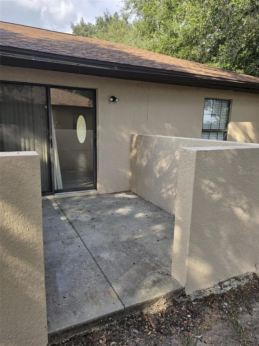 Private back patio with privacy wall