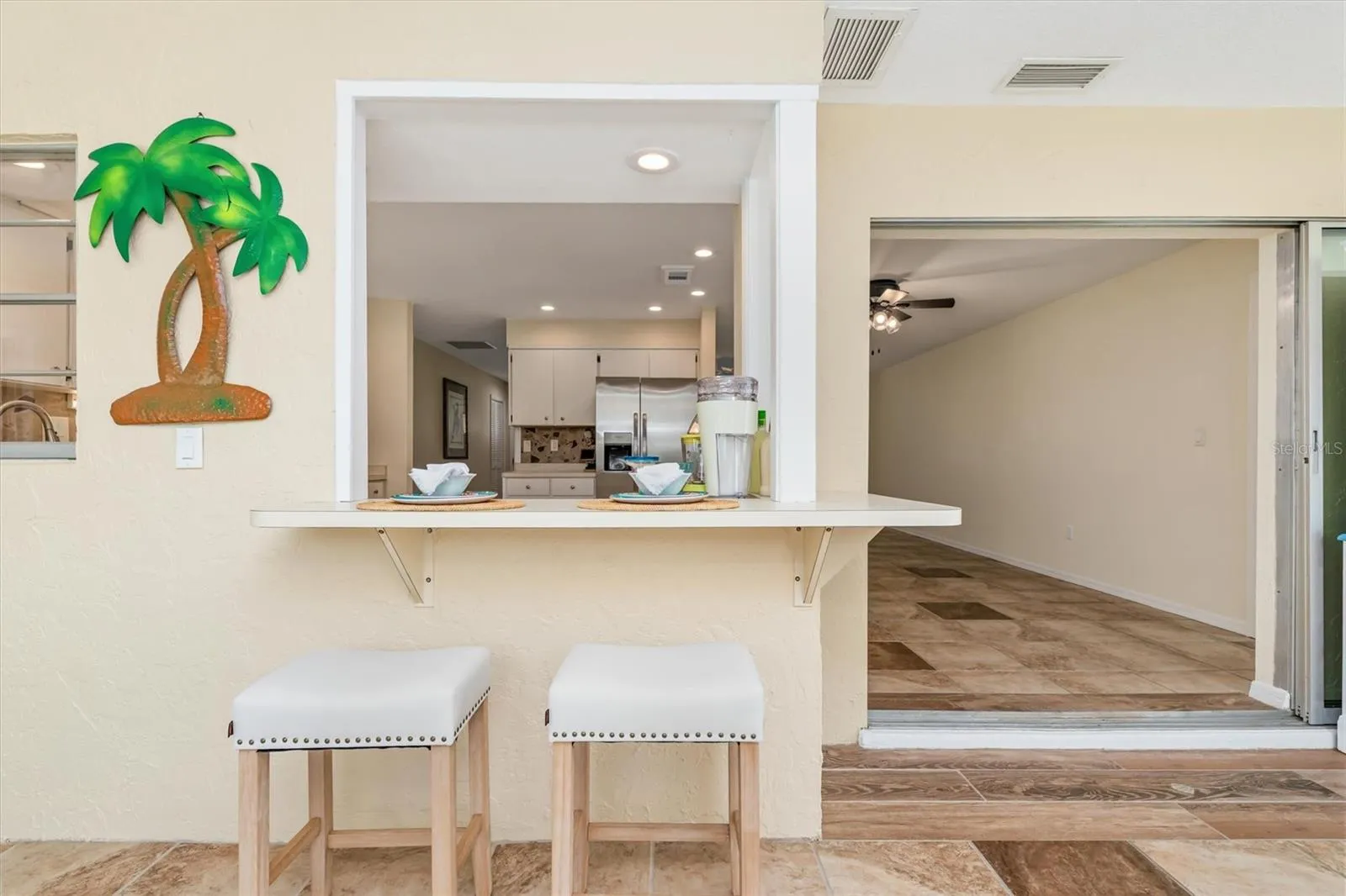 on lanai-2nd eat at bar looking back into the kitchen- perfect for afternoons from the pool