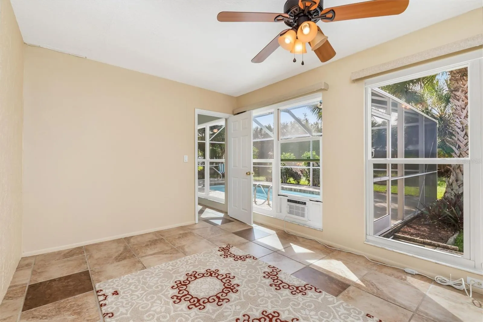 3rd bedroom looking out to pool-so much natural light-great for arts &amp; craft area or mancave