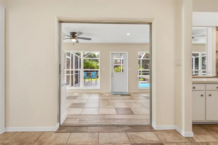 View from dining room to lanai and pool (pocket door can close)