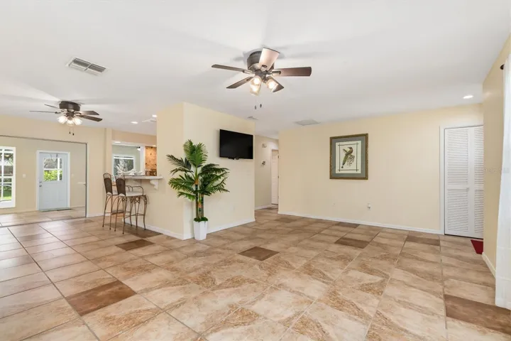 Showing off living room on right, kitchen center and dining area on left