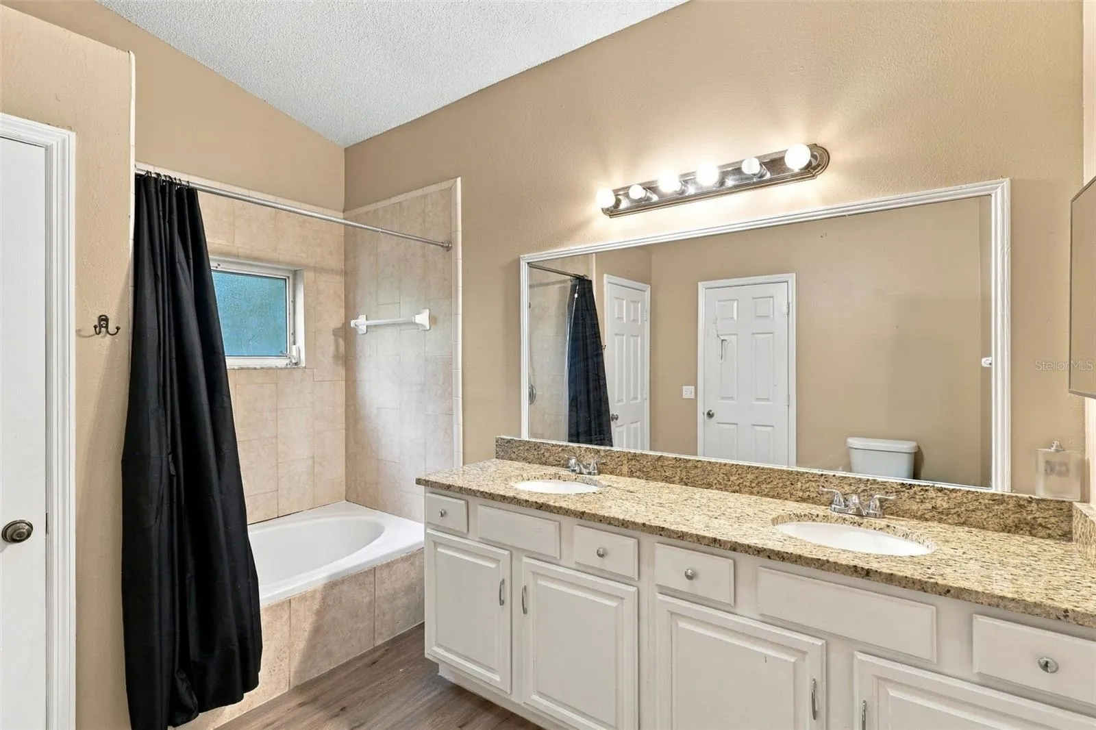 Primary bathroom, double vanity, large soaking tub and shower.