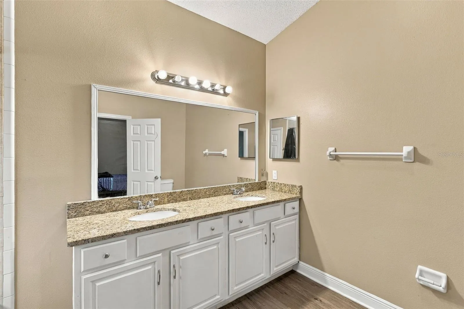 Primary bathroom, double sink vanity, stone countertop and large soaking tub and shower combo.