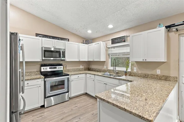 Stone countertops and stainless steel appliances.