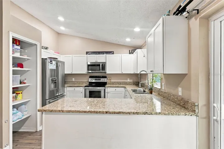 Stainless Steel appliances, stone countertops.