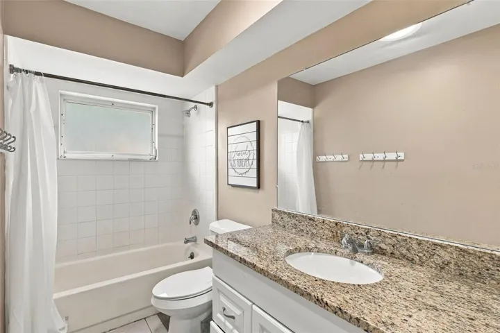 Bathroom 2- Stone countertops, bath/shower combo