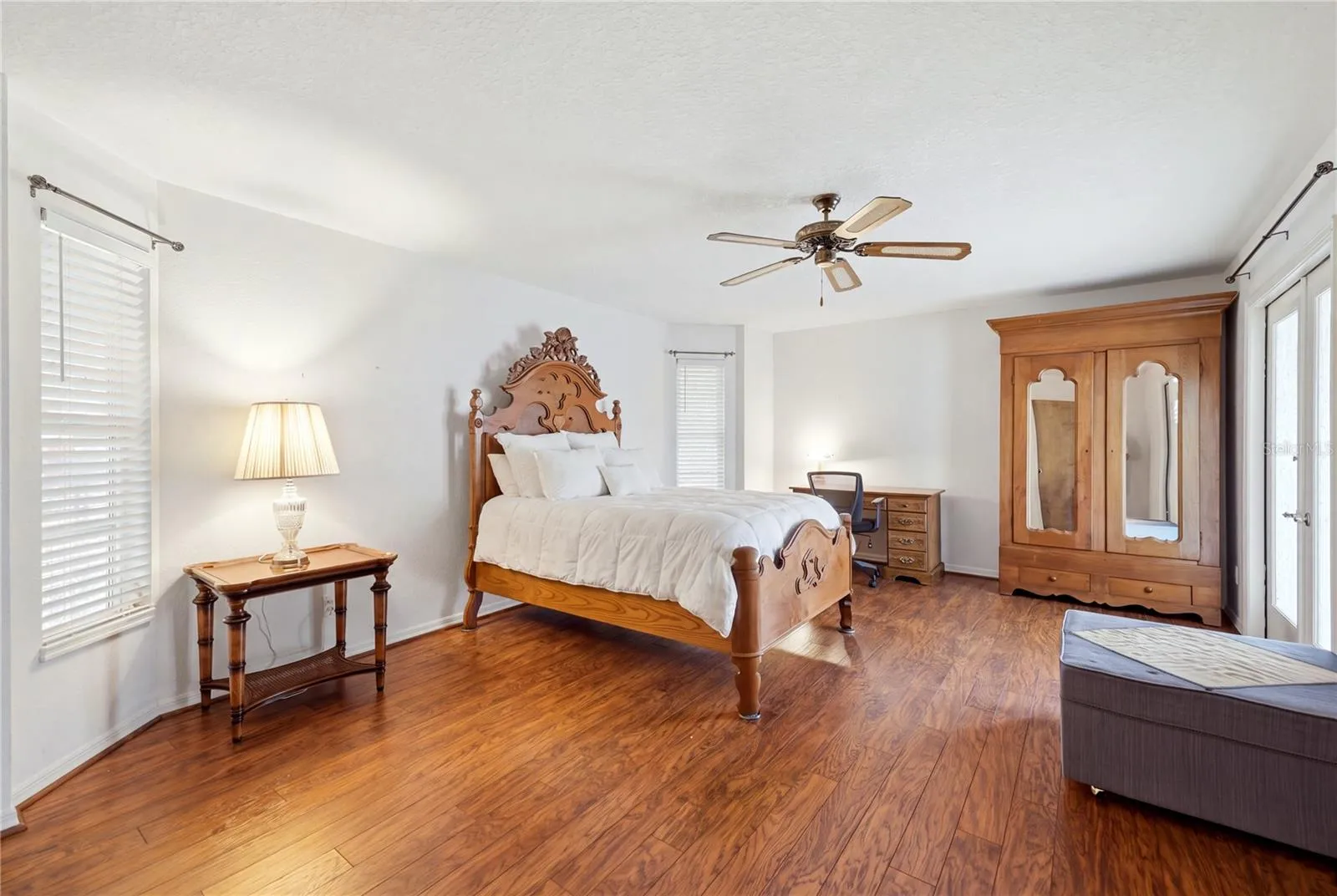 Primary ensuite bedroom with French door opening to the lanai