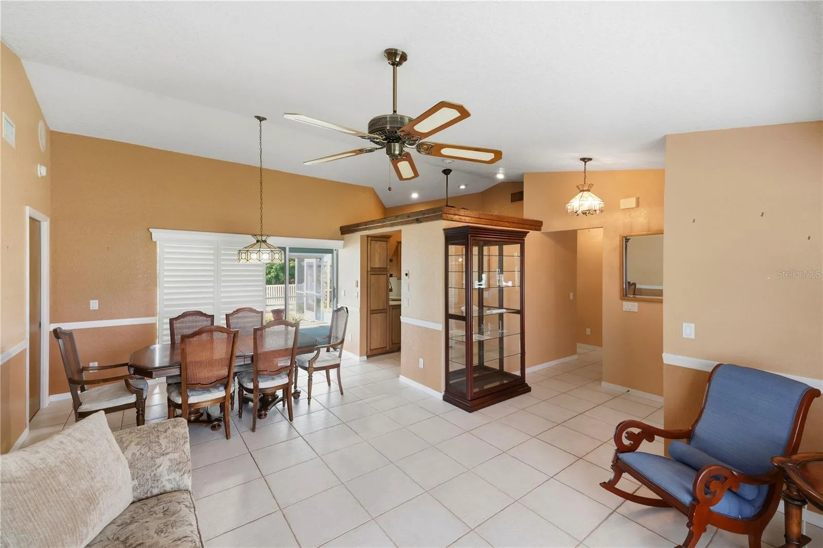 living &amp; dining rooms with cathedral ceiling and chair rail