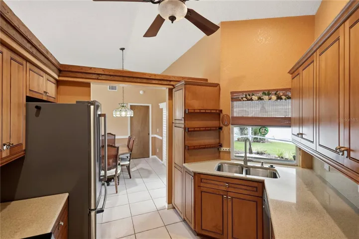 wood cabinets with pullout drawers, pantry, solid surface counter