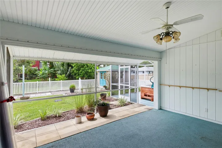 fenced, parklike backyard with additional enclosed hot tub lanai