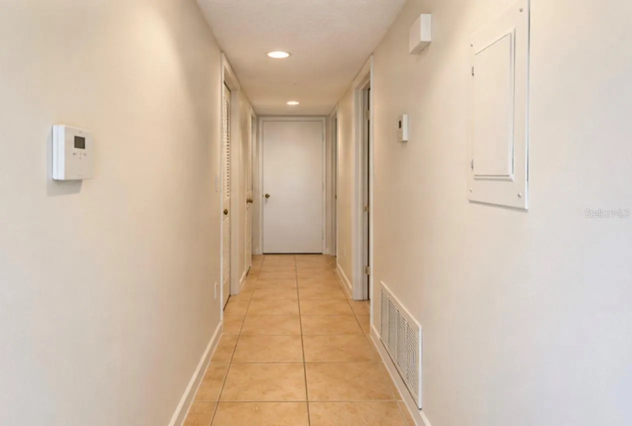 Hallway to bedrooms; laundry closet at far end right.