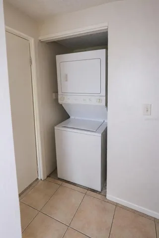 Stacked washer and dryer in laundry closet.