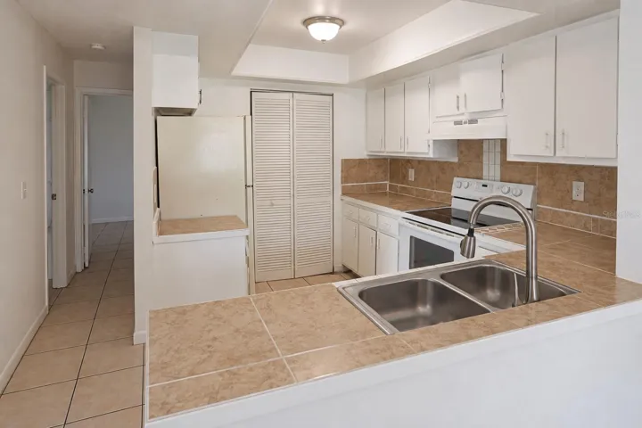 Kitchen with pantry and opening from dining area.  Bedrooms at left.