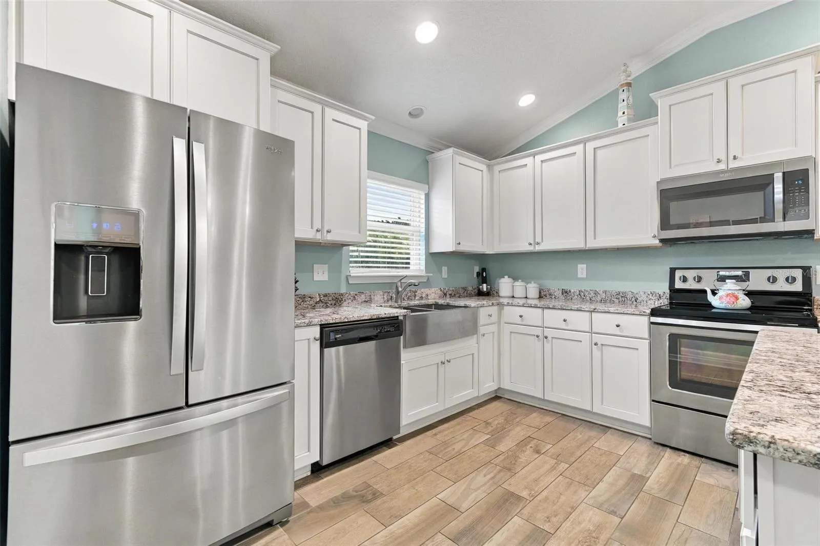 Tile floors throughout living areas (kitchen, great room, entryway)