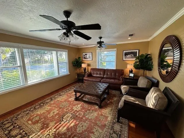Spacious living area with picture windows looking out to river