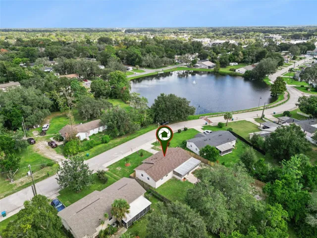 Aerial Lake Proximity Pin: Drone photo showcasing the property location pin relative to the nearby neighborhood lake and surrounding street layout