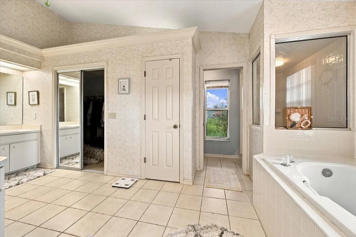Primary bath with separate garden tub and shower and water closet