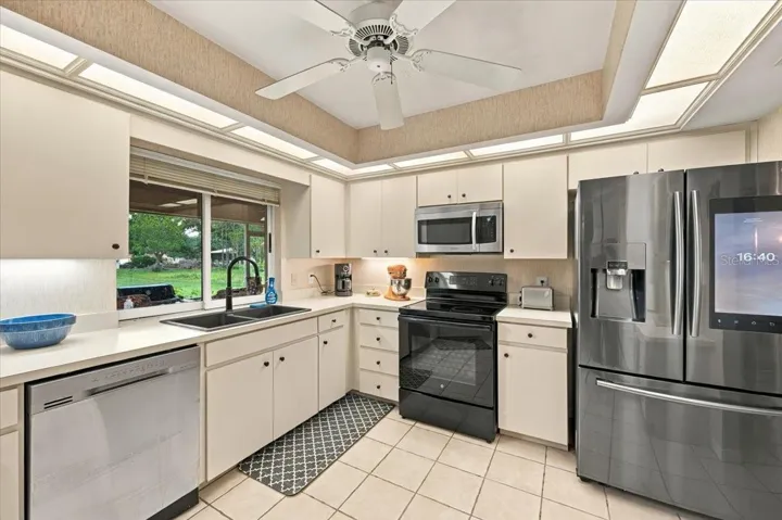 Kitchen with pass through window to back screened lanai
