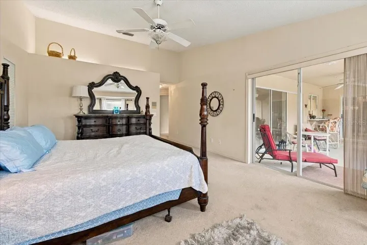Primary Bedroom with sliding doors out to the back screened lanai