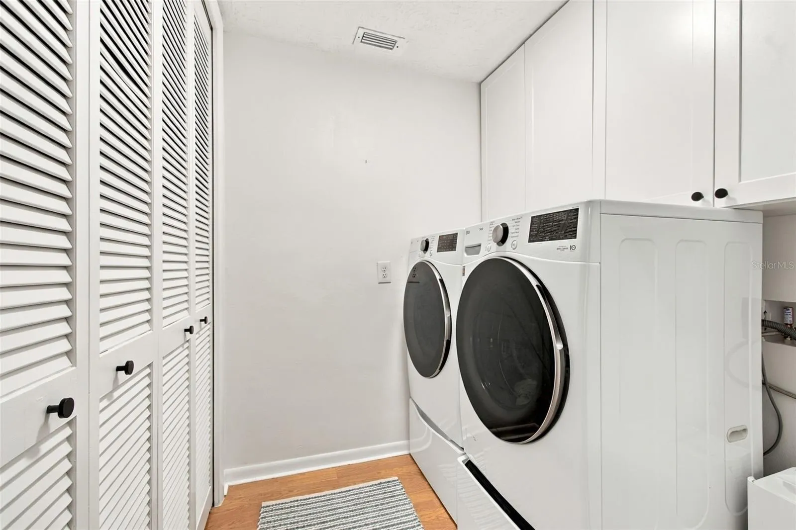 Indoor Laundry with pantry area and utility storage