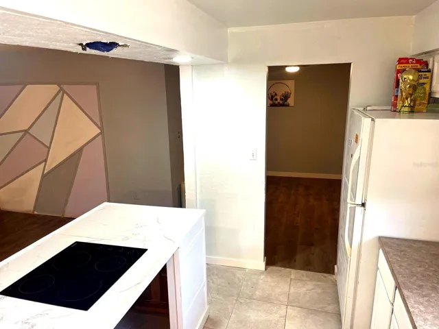 Kitchen with ample cabinets and hallway access