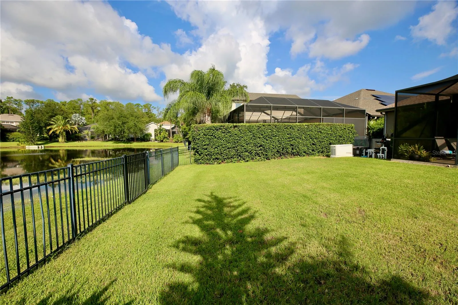 Fenced in yard overlooking Pond
