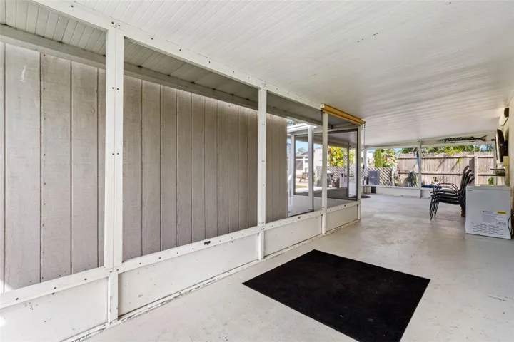 The spacious screened lanai offers a long stretch of covered outdoor living space with plenty of room for dining, lounging, and gathering while staying shaded from the Florida sun.