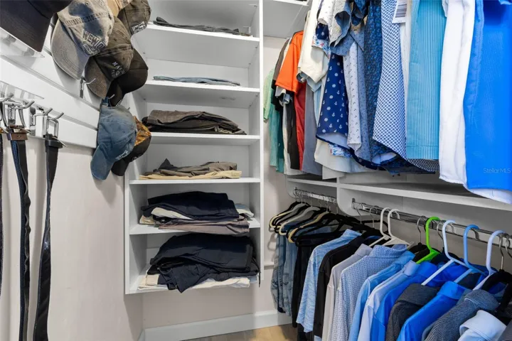 A well-organized walk-in closet in the primary suite offers built-in shelving, double hanging space, and plenty of room to keep clothing and accessories neatly arranged.
