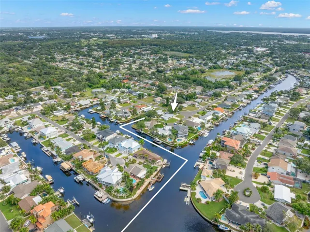 A dramatic aerial view captures Baywood Village’s interconnected canal system and the boating lifestyle that defines the neighborhood, with waterfront homes, private docks, and direct saltwater access throughout the community.