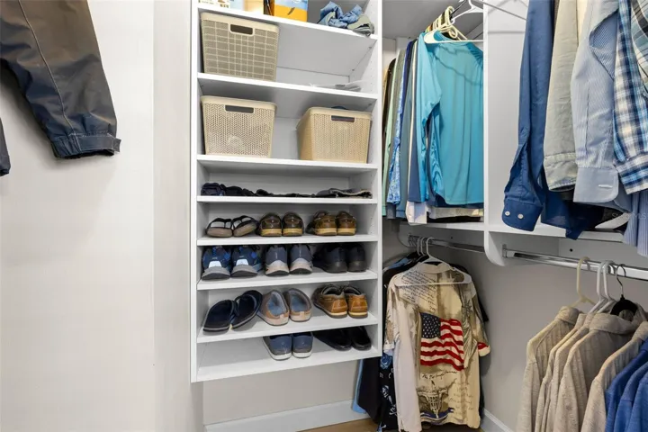 A well-organized walk-in closet in the primary suite offers built-in shelving, double hanging space, and plenty of room to keep clothing and accessories neatly arranged.
