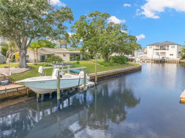 Set along a saltwater canal with Gulf access and no fixed bridges, the property’s 10,000-pound boat lift puts you just steps from getting out on the water.