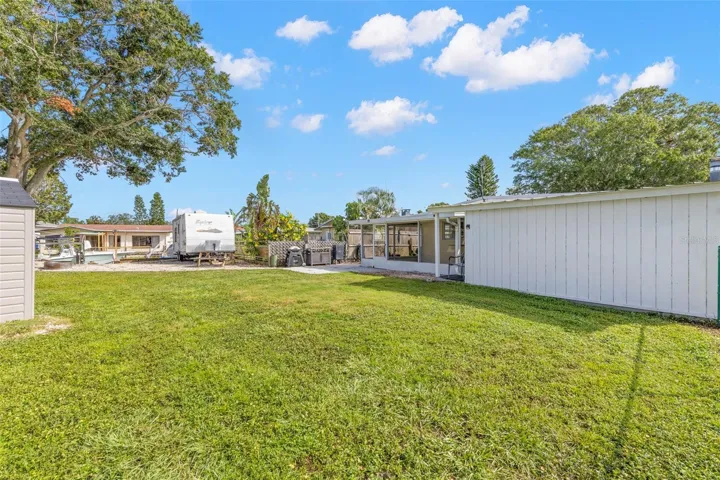 The oversized 11,800-square-foot (.27-acre) property continues into a broad backyard with generous lawn space, fencing for added separation, and plenty of room for pets, play, gardening, or outdoor projects.