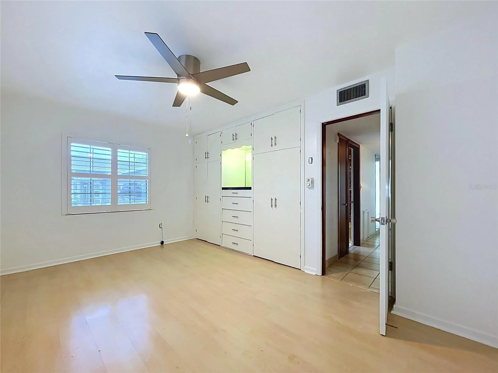 Bedroom 2 with ceiling fan and windows